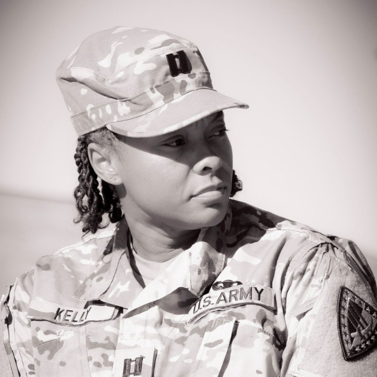 Black and white photo of a woman in an army uniform.