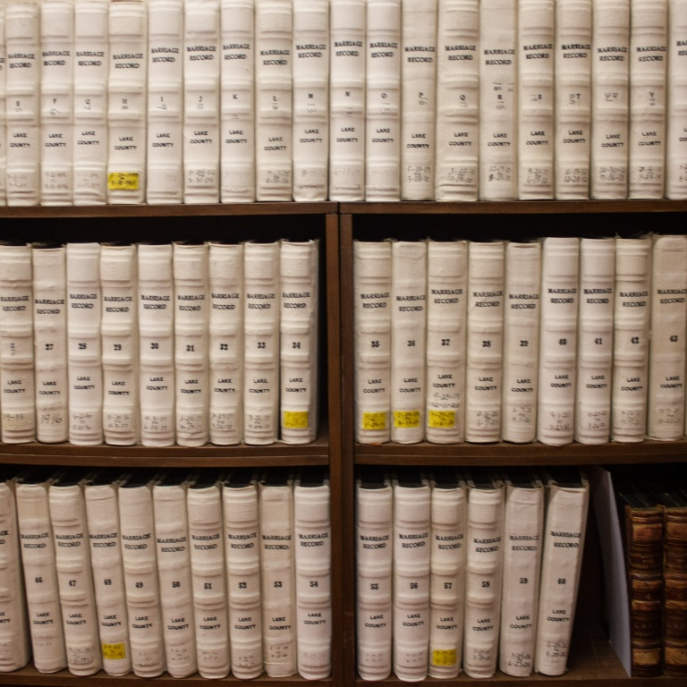 Rows of white books on a shelf.